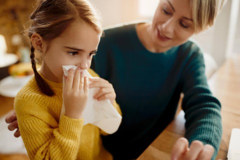 little-girl-blowing-nose-while-being-with-her-mother-home-1-1