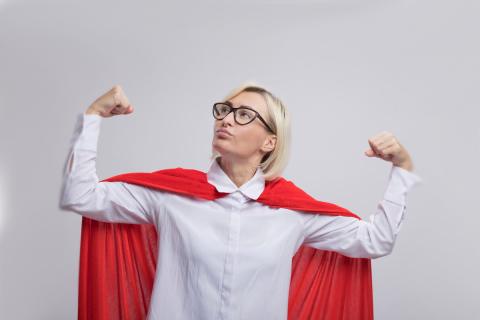 confident-middle-aged-blonde-superhero-woman-red-cape-wearing-glasses-doing-strong-gesture-looking-up-isolated-white-wall-X